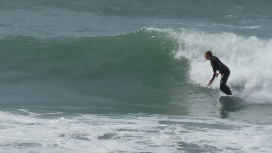 Tom surfing a breaking wave